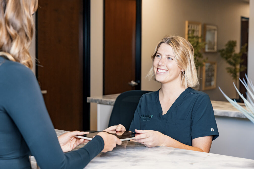A woman checks in to Alpine Wellness for her consultation for weight reducing medicine in Reno.